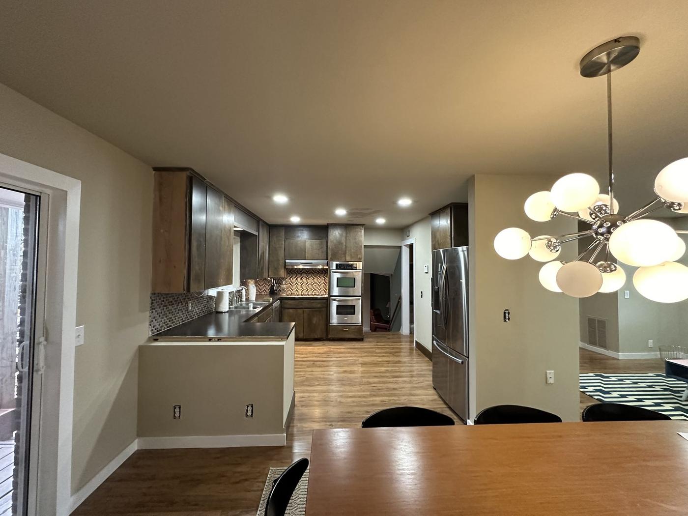 Remodeled kitchen with dark wood cabinets open to the dining area