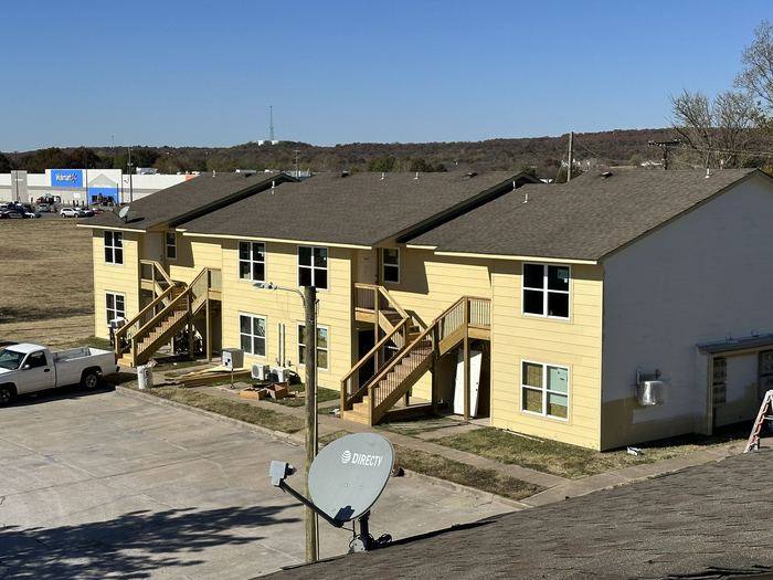 Building exterior after new siding, trim and stairs